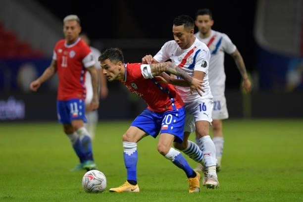 Charles Aránguiz of Chile fights for the ball with Ángel Cardozo of Paraguay during a Group A match between Chile and Paraguay as part of Copa...