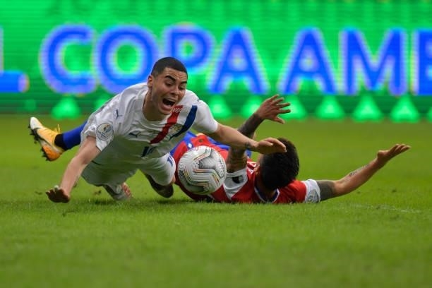 Miguel Almiron of Paraguay falls down with Charles Aránguiz of Chile during a Group A match between Chile and Paraguay as part of Copa America Brazil...
