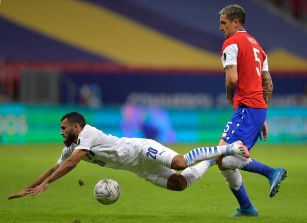Antonio Bareiro of Paraguay falls down against Enzo Roco of Chile during a Group A match between Chile and Paraguay as part of Copa America Brazil...