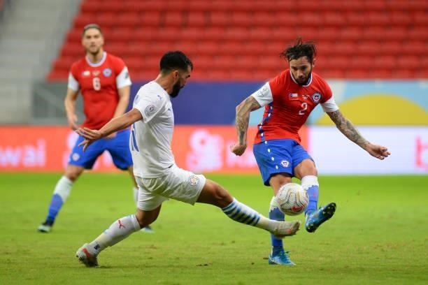 Eugenio Mena of Chile kicks the ball against Gustavo Gomez of Paraguay during a Group A match between Chile and Paraguay as part of Copa America...
