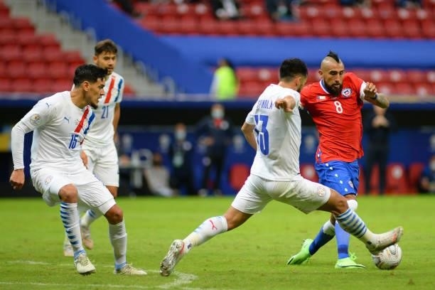 Arturo Vidal of Chile fights for the ball with Alberto Espinola of Paraguay during a Group A match between Chile and Paraguay as part of Copa America...