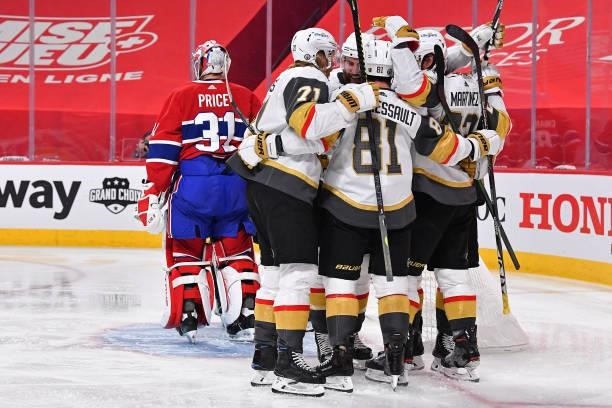 Alec Martinez of the Vegas Golden Knights is congratulated by his teammates after scoring a goal past Carey Price of the Montreal Canadiens during...