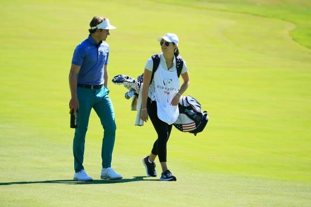 James Nicholas walks with his caddie during the first round of the Live And Work In Maine Open held at Falmouth Country Club on June 24, 2021 in...