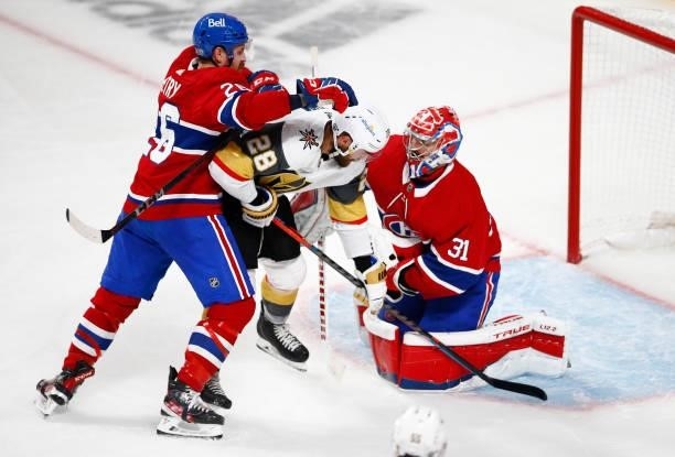 William Carrier of the Vegas Golden Knights is checked by Jeff Petry of the Montreal Canadiens infront of Carey Price during the third period in Game...
