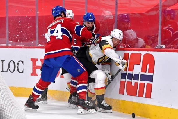 William Karlsson of the Vegas Golden Knights is defended by Joel Edmundson and Shea Weber of the Montreal Canadiens during the third period in Game...
