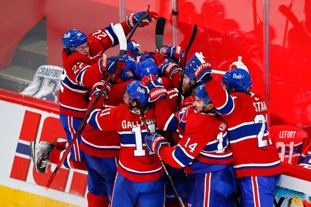 Artturi Lehkonen of the Montreal Canadiens is congratulated by his teammates after scoring the game-winning goal during the first overtime period...