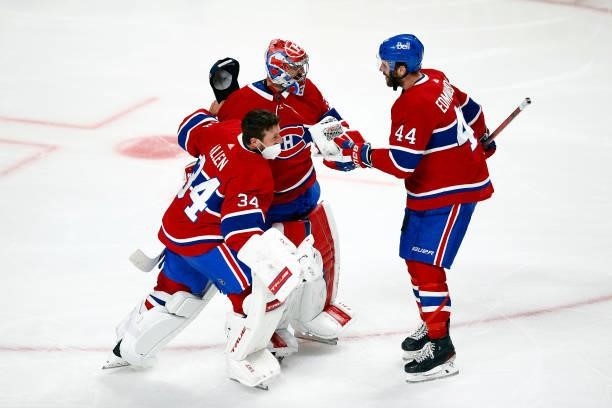Jake Allen, Carey Price and Joel Edmundson of the Montreal Canadiens celebrate the team's 3-2 overtime victory against the Vegas Golden Knights in...