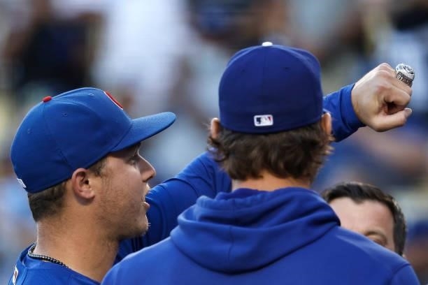 Joc Pederson of the Chicago Cubs shows off his World Series Ring that was presented to him by Clayton Kershaw of the Los Angeles Dodgers prior to a...