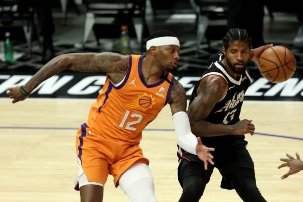 Torrey Craig of the Phoenix Suns pressures Paul George of the LA Clippers during the second half of game three of the Western Conference Finals at...