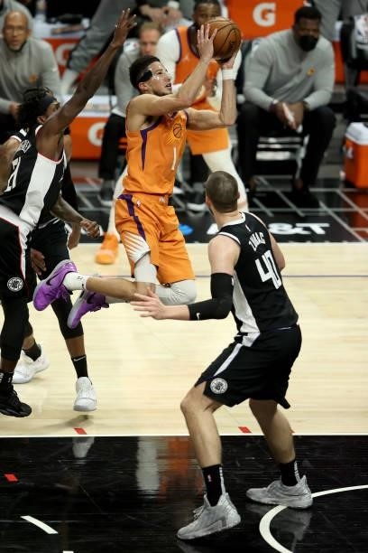 Devin Booker of the Phoenix Suns goes up for a shot against Ivica Zubac of the LA Clippers during the second half of game three of the Western...