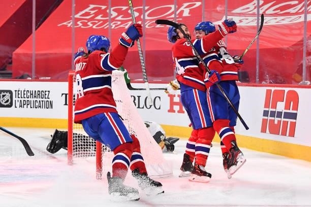 Artturi Lehkonen of the Montreal Canadiens is congratulated by Phillip Danault and Ben Chiarot after scoring the game-winning goal during the first...