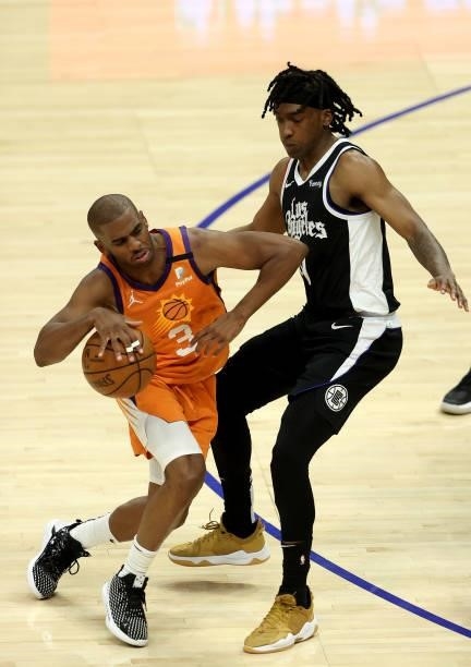 Chris Paul of the Phoenix Suns bumps Terance Mann of the LA Clippers during the second half of game three of the Western Conference Finals at Staples...