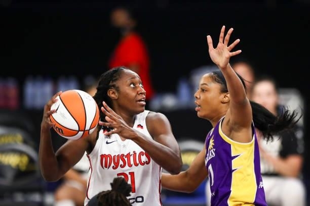 Center Tina Charles of the Washington Mystics drives to the basket defended by forward/center Kristine Anigwe of the Los Angeles Sparks in the first...
