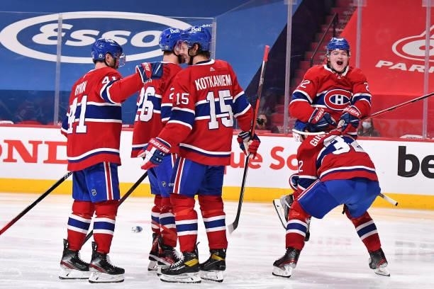 Cole Caufield of the Montreal Canadiens celebrates with his teammates after the game-winning overtime goal scored by Artturi Lehkonen against the...