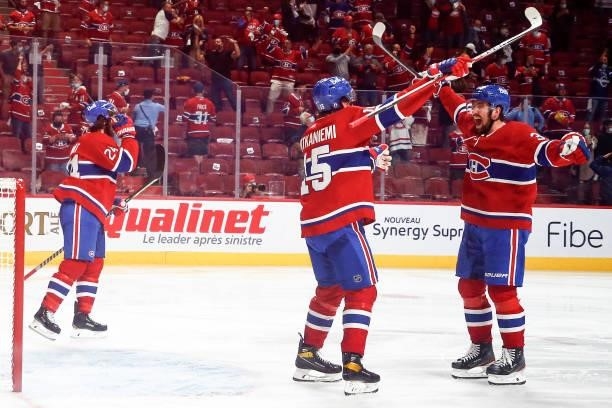Jesperi Kotkaniemi and Erik Gustafsson of the Montreal Canadiens celebrate the game-winning overtime goal scored by Artturi Lehkonen against the...
