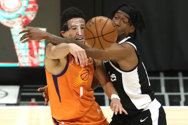 Terance Mann of the LA Clippers pressures Devin Booker of the Phoenix Suns during the second half of game three of the Western Conference Finals at...