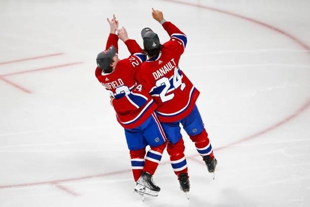 Phillip Danault and Cole Caufield of the Montreal Canadiens celebrate the game-winning overtime goal scored by Artturi Lehkonen against the Vegas...