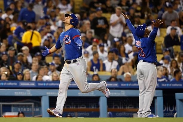 Willson Contreras of the Chicago Cubs and Willie Harris of the Chicago Cubs react as Contreras rounds third base after hitting a two run home run...