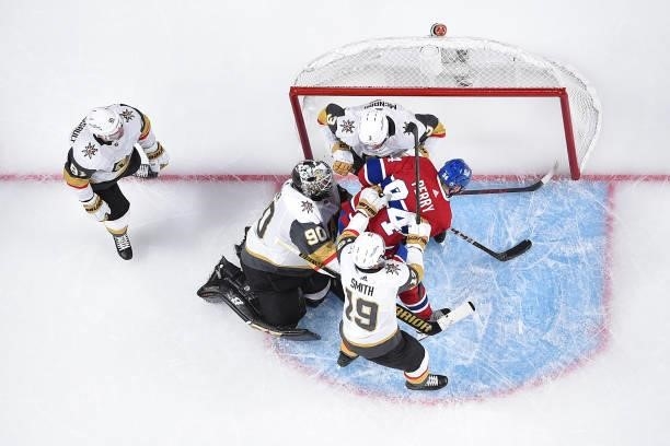 Corey Perry of the Montreal Canadiens collides with Brayden McNabb and Robin Lehner of the Vegas Golden Knights during the third period in Game Six...