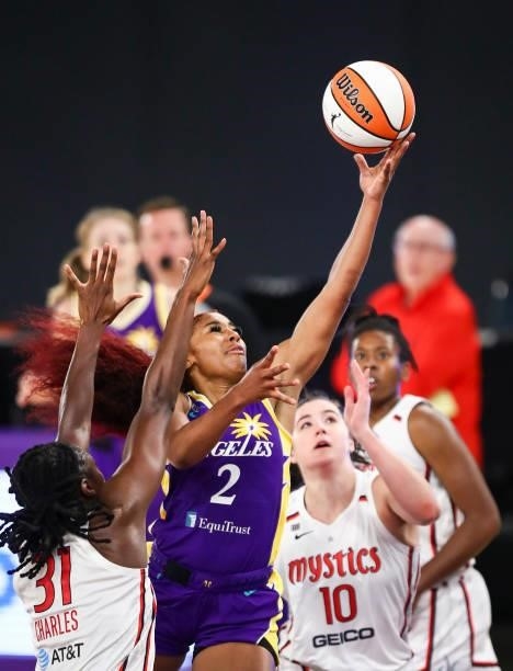 Guard Te'a Cooper of the Los Angeles Sparks shoots defended by center Tina Charles of the Washington Mystics at Los Angeles Convention Center on June...