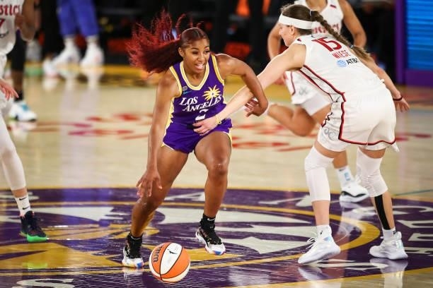 Guard Te'a Cooper of the Los Angeles Sparks is fouled by guard Sydney Wiese of the Washington Mystics in the second half at Los Angeles Convention...