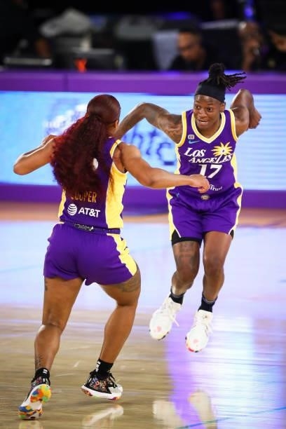 Guard Te'a Cooper of the Los Angeles Sparks celebrates her shot against the Washington Mystics with guard Erica Wheeler at Los Angeles Convention...