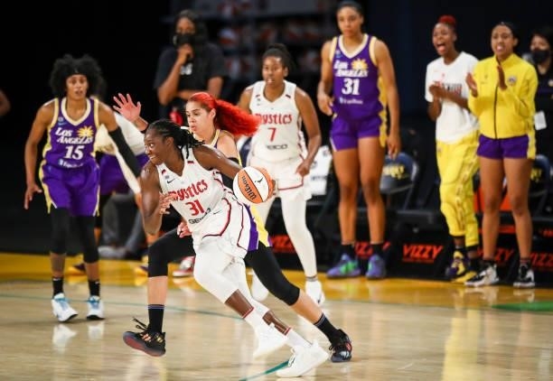 Center Tina Charles of the Washington Mystics handles the ball defended by center Amanda Zahui B of the Los Angeles Sparks in the second half at Los...
