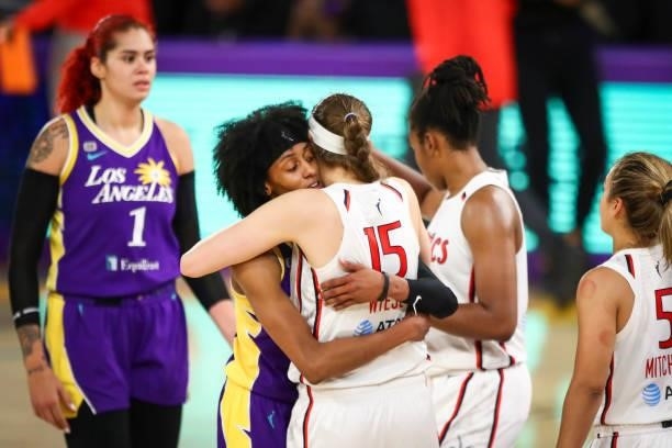 Guard Brittney Sykes of the Los Angeles Sparks hugs former teammate guard Sydney Wiese of the Washington Mystics after the game at Los Angeles...