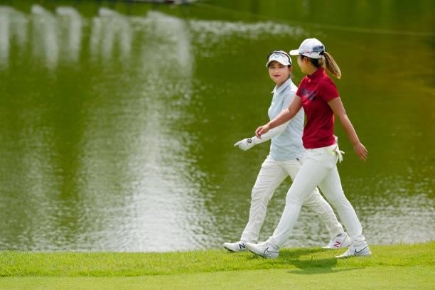 Hana Lee of South Korea and Nanako Ueno of Japan walk on the 18th fairway during the final round of the JLPGA Pro Test at Shizu Hills Country Club on...
