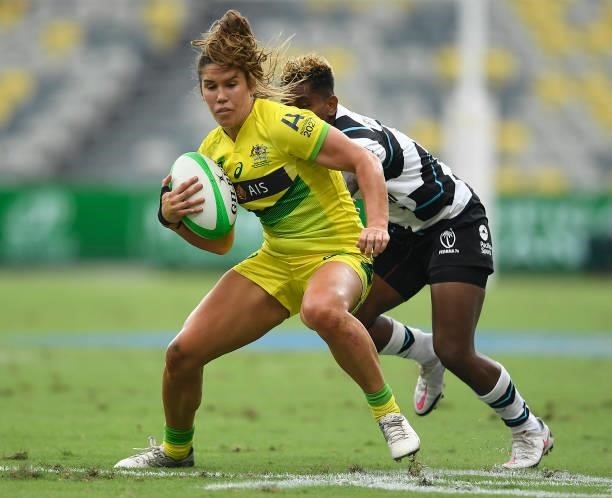 Charlotte Caslick of Australia skips out of a tackle during the Oceania Sevens Challenge match between Fiji and Australia at Queensland Country Bank...