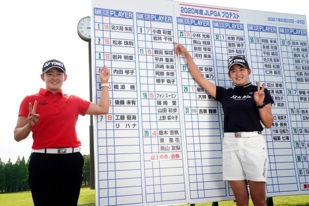 Akie Iwai and Chisato Iwai of Japan point their names on the leaders' board as they celebrate passing the professional test following the final round...