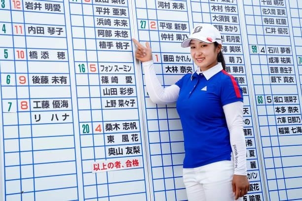 Miyu Abe of Japan points her name on the leaders board as she celebrates passing the professional test following the final round of the JLPGA Pro...