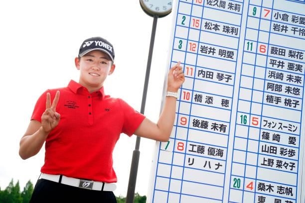 Akie Iwai of Japan points her name on the leaders board as she celebrates passing the professional test following the final round of the JLPGA Pro...
