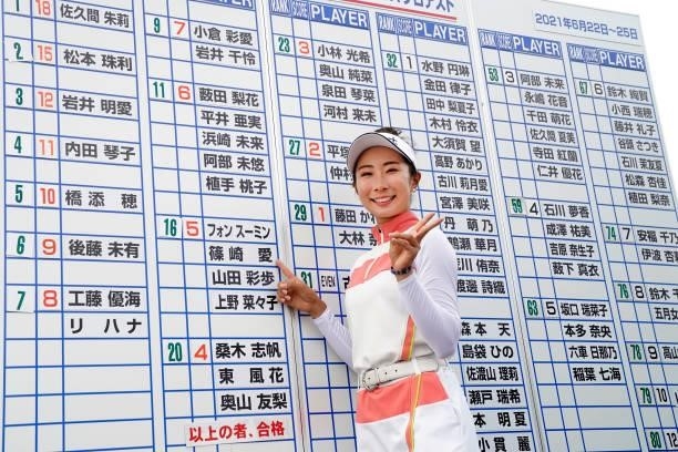 Mana Shinozaki of Japan points her name on the leaders board as she celebrates passing the professional test following the final round of the JLPGA...