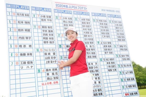 Nanako Ueno of Japan points her name on the leaders board as she celebrates passing the professional test following the final round of the JLPGA Pro...