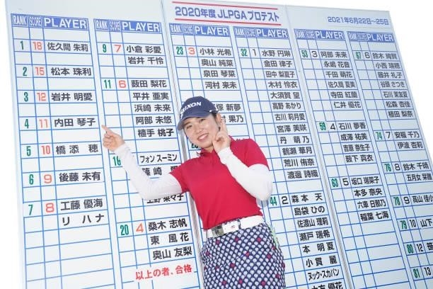 Kotoko Ueda of Japan points her name on the leaders board as she celebrates passing the professional test following the final round of the JLPGA Pro...