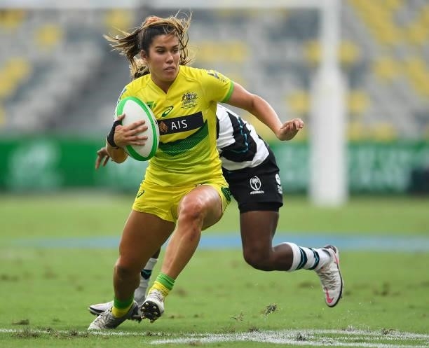 Charlotte Caslick of Australia skips out of a tackle during the Oceania Sevens Challenge match between Fiji and Australia at Queensland Country Bank...