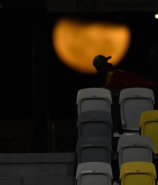 Spectators are seen silhouetted against the moon during the Oceania Sevens Challenge at Queensland Country Bank Stadium on June 25, 2021 in...