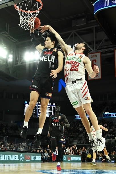 Yudai Baba of Melbourne United dunks under pressure from Corey Shervill of the Wildcats during game three of the NBL Grand Final Series between...