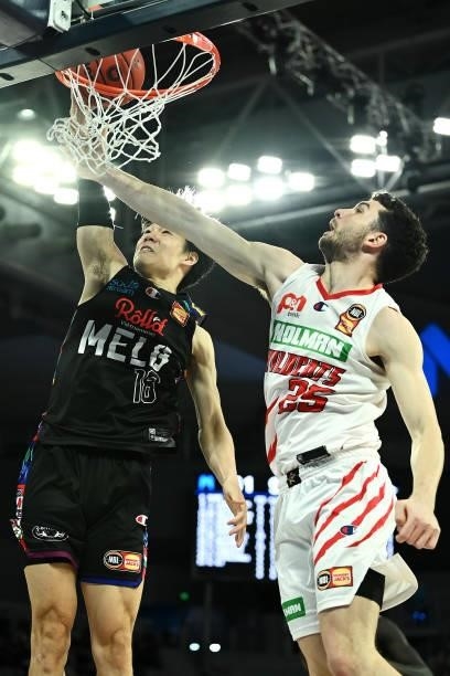 Yudai Baba of Melbourne United dunks under pressure from Corey Shervill of the Wildcats during game three of the NBL Grand Final Series between...