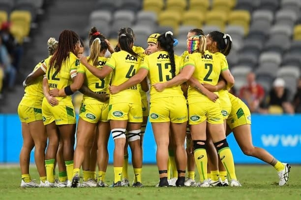 Australia gather in a huddle during the Oceania Sevens Challenge match between Australia and Oceania at Queensland Country Bank Stadium on June 25,...