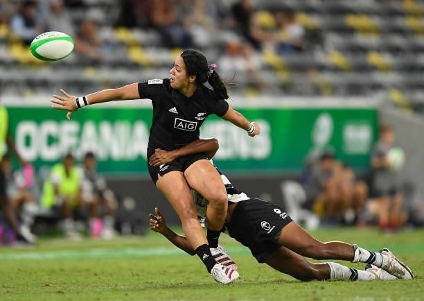 Stacey Waaka of New Zealand gets a pass away despite the tackle of Sesenieli Donu of Fiji during the Oceania Sevens Challenge match between New...