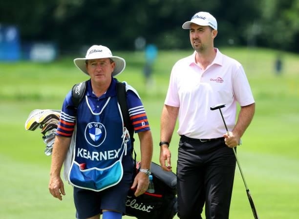 Niall Kearney of Ireland and his caddie walking off of the 18th green during the second round of The BMW International Open at Golfclub Munchen...