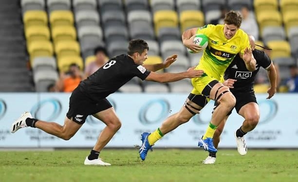 Tim Anstee of Australia is tackled during the Oceania Sevens Challenge match between New Zealand and Australia at Queensland Country Bank Stadium on...