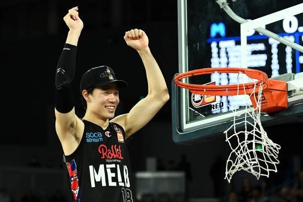 Yudai Baba of Melbourne United cuts off the net as he celebrates victory after game three of the NBL Grand Final Series between Melbourne United and...