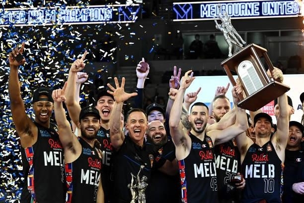 The Melbourne United team celebrate victory with the trophy after game three of the NBL Grand Final Series between Melbourne United and the Perth...