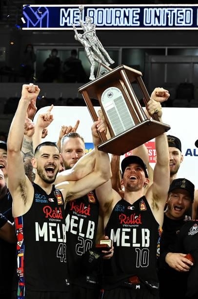 Chris Goulding and Mitch McCarron and the Melbourne United team celebrate victory with the trophy after game three of the NBL Grand Final Series...