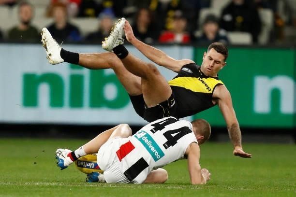 Callum Wilkie of the Saints and Jack Graham of the Tigers compete for the ball during the round 15 AFL match between the Richmond Tigers and the St...