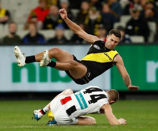 Callum Wilkie of the Saints and Jack Graham of the Tigers compete for the ball during the round 15 AFL match between the Richmond Tigers and the St...