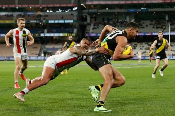Bradley Hill of the Saints tackles Marlion Pickett of the Tigers during the round 15 AFL match between the Richmond Tigers and the St Kilda Saints at...
